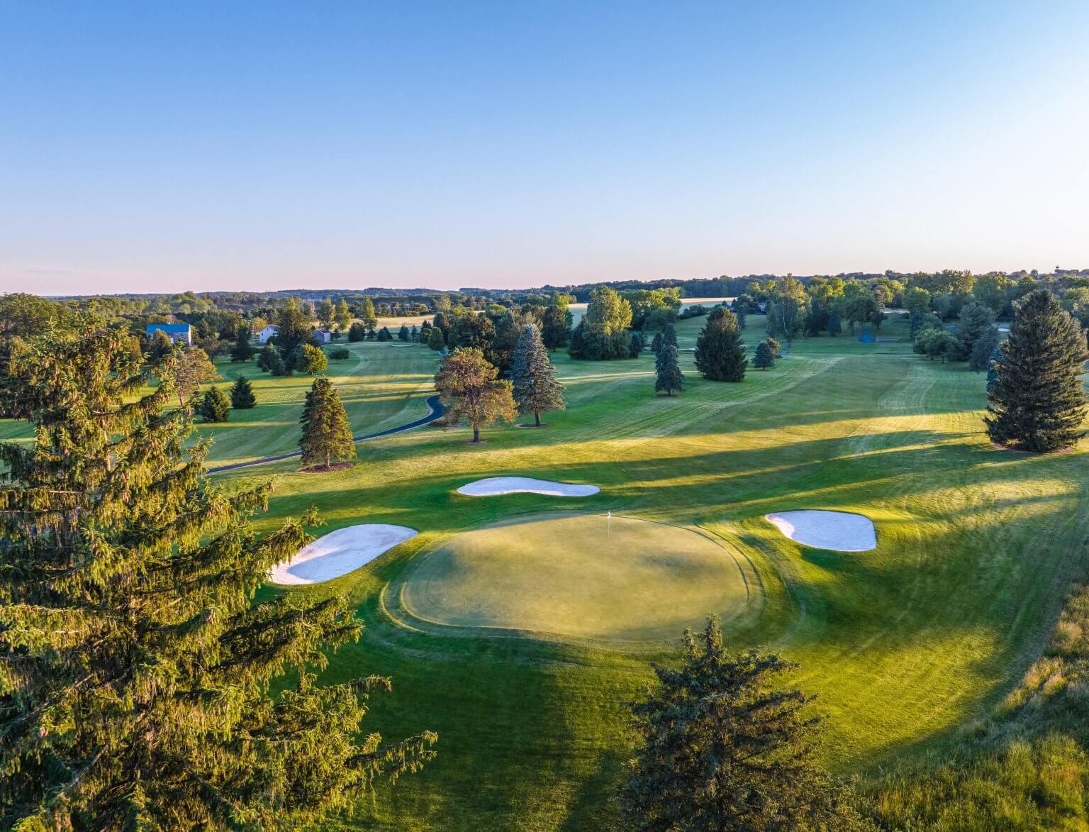 Aerial view of a green guarded by bunkers