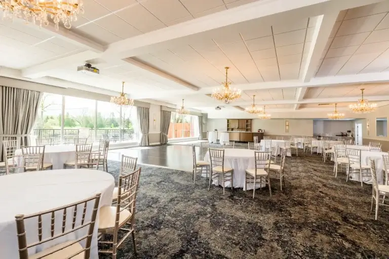 Round tables, dance floor and a long run of windows