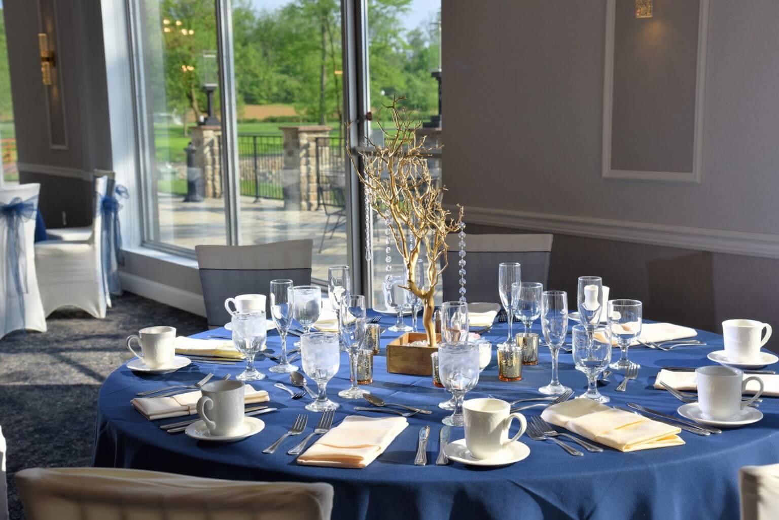 Gold branch centerpiece and patio beyond