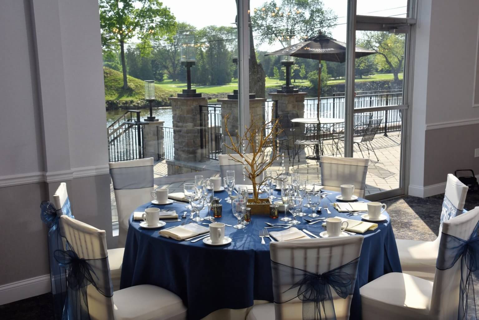 Navy linens framed by lake and lawn