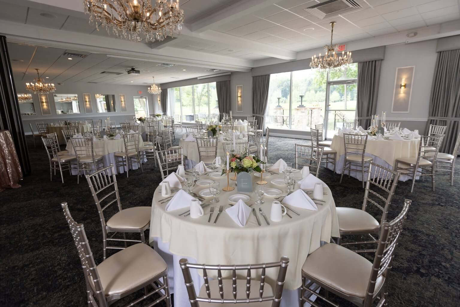 Silver chairs, cream linens and crystal light